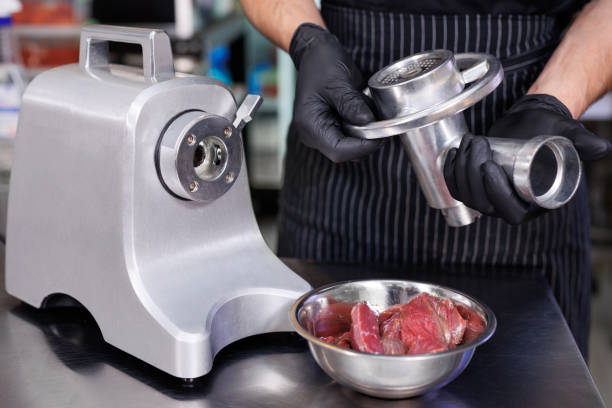 istock The cook assembles a electric meat grinder before cooking minced meat. 2103649451
