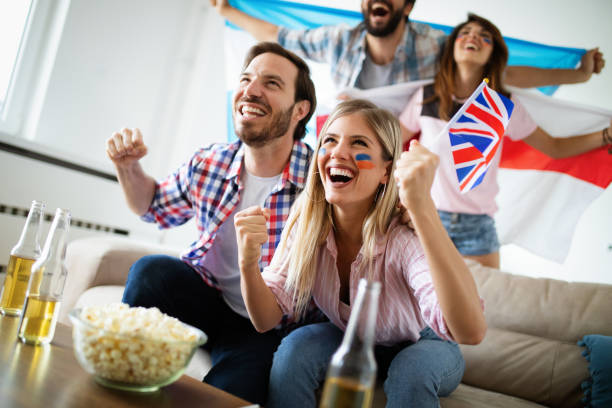 istock Group of multi-ethnic people celebrating football game 2103652064
