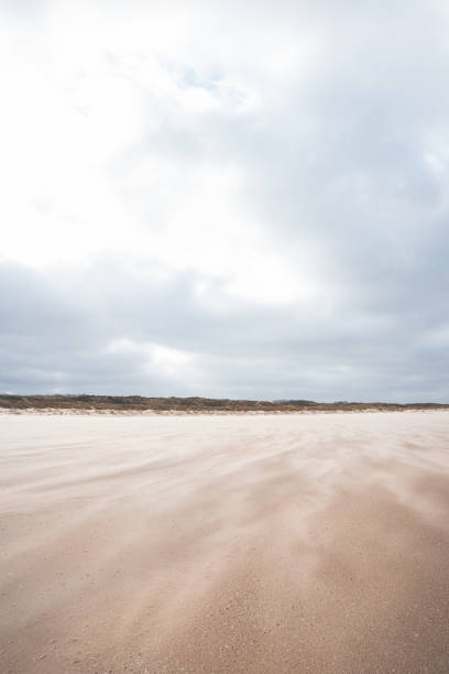 Sand grains break off the ground and form currents due to high winds on a sandy beach near the town of Blankenberge in western Belgium.