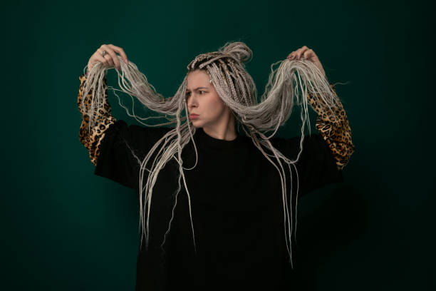 istock Woman With Dreadlocks Standing in Front of Green Background 2103687053