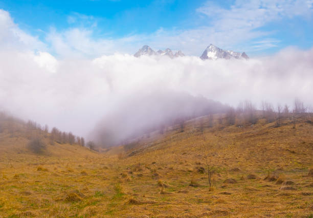 Beautiful high angle panoramic view from mountain peaks in the European alps in Switzerland. Hazy atmosphere on a beautiful autumn day.