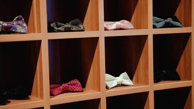 Multicolored man's bow ties on showcase in luxury shop