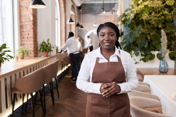 istock Young Black Waitress At Work In Restaurant 2103774431