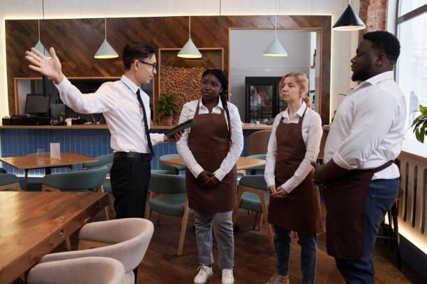 istock Manager And Waiting Staff Discussing Plans For Workday 2103778057