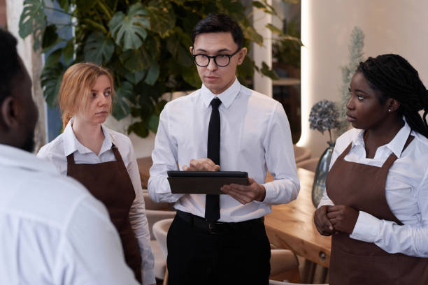 istock Restaurant Manager Working With Waiting Staff 2103778060