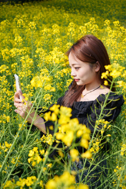 istock Female tourist among rape flowers 2103798183