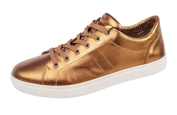 istock A gold shoe with a shiny, glittery appearance. 2103833261