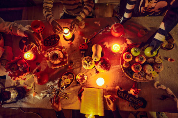 istock Above view of unrecognizable people at dining table on Halloween. 2103833778