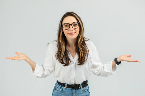 istock A young woman with glasses and a friendly expression stands with her arms open 2103842482