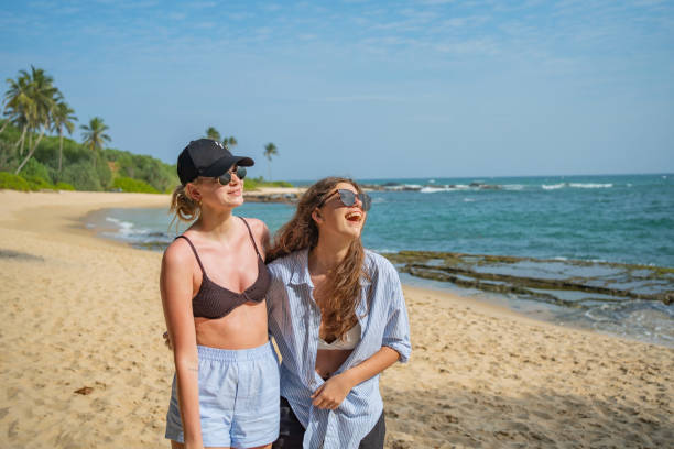 istock Friends enjoy beach vacation together 2103842487