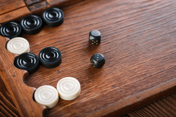 Backgammon. Game field in a backgammon with cubes and counters. Game concept. Board game. Hobby. Dice and checkers on the playing field for a game of backgammon.