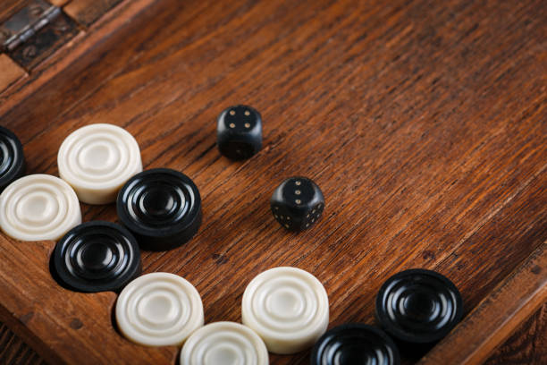 Backgammon board with dice and checkers on triangles