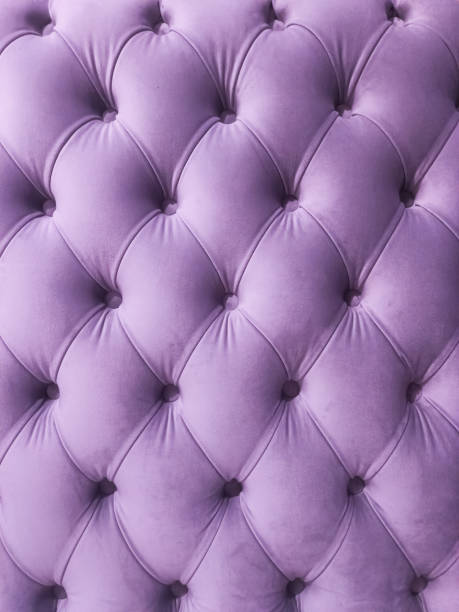 istock Violet purple velvet capitone textile background, retro Chesterfield style checkered soft tufted fabric furniture diamond pattern decoration with buttons 2103868664