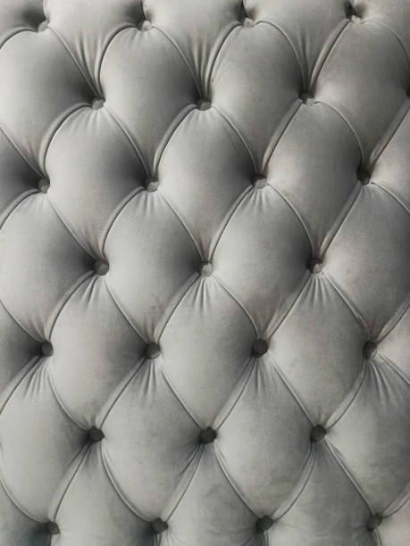 istock Grey velvet capitone textile background, retro Chesterfield style checkered soft tufted fabric furniture diamond pattern decoration with buttons 2103872436