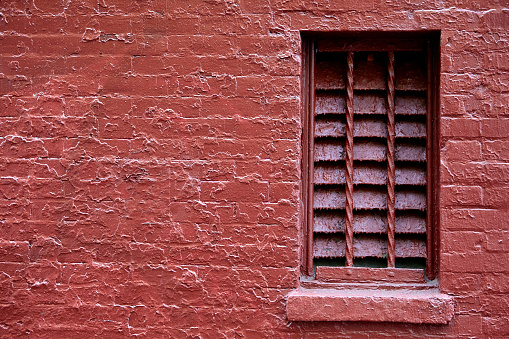 Vented Opening in a Painted Red Brick Wall