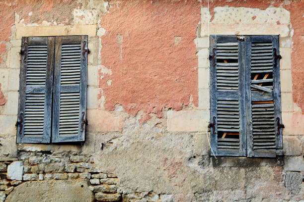 Broken Blue Shutters in an Orange Building