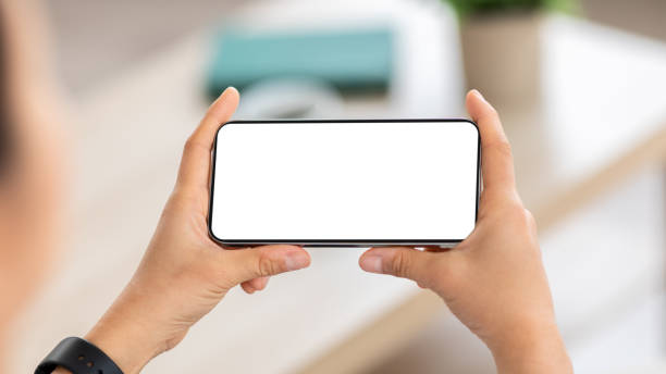 istock Smartphone with white blank screen in woman hands 2103895600