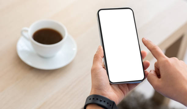 istock Cropped of woman scrolling on smartphone while drinking coffee 2103895966