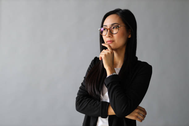 istock A young, sad Asian businesswoman with a troubled expression 2103896715