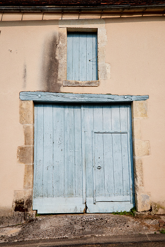 Closed Large Door with Small Inset Door with Window Shudder Above