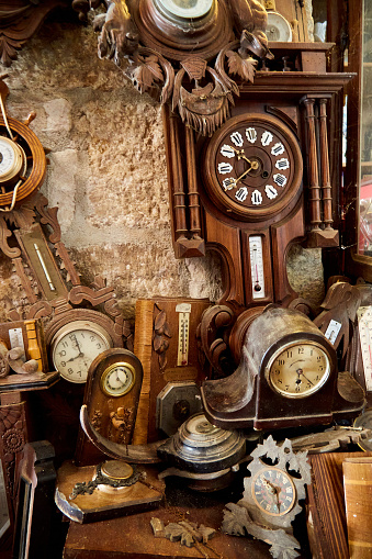 Old Clocks and Thermometers on a Stone Wall
