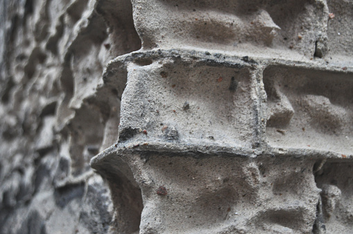 a close-up of a textured stone wall, capturing the intricate details and imperfections that make it visually interesting