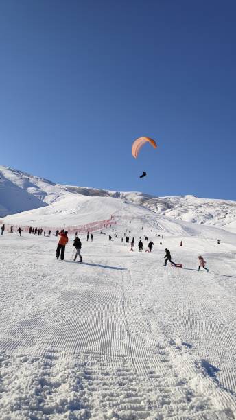 istock People having fun at the ski resort. 2103905697