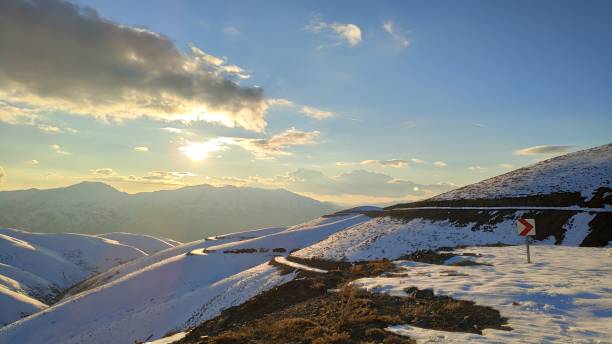 istock cloudy blue sky and snow-capped mountains 2103913448