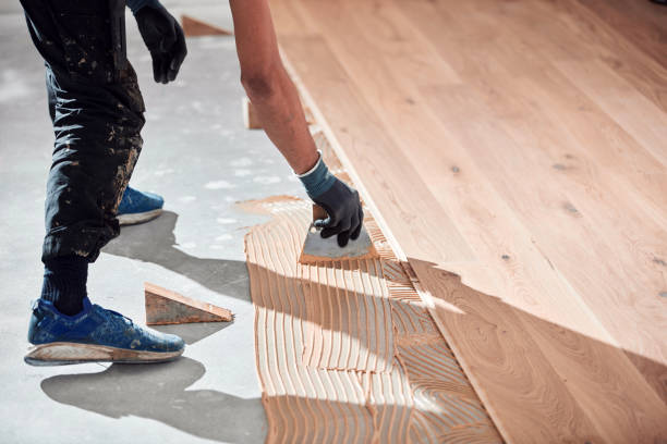 istock Professional handyman installing laminate flooring in a new apartment. 2103917609