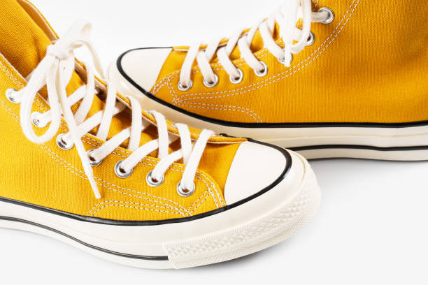 istock Yellow sneakers on white background with copy space. Youth shoes. 2103918639