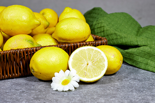 halfah basket full of lemons on wood table with plastic squeeze, Gardening concept, lemonade