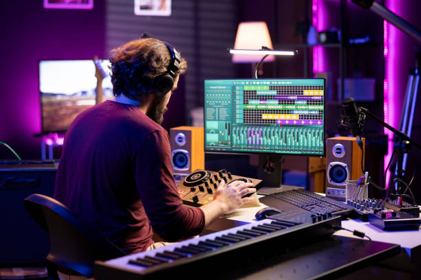 istock Skilled producer mixing and mastering sounds on stereo console 2103946490