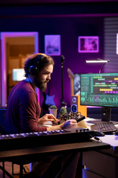 istock Sound engineer editing audio recordings with daw software and mixing console 2103947515