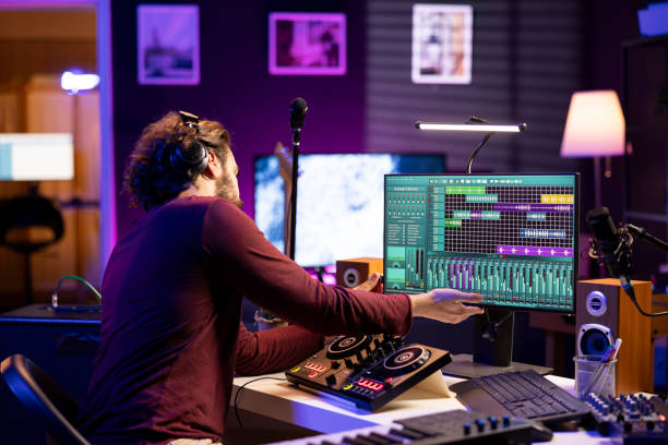 istock Musical artist using usb stick to edit past audio recordings on daw software 2103949056