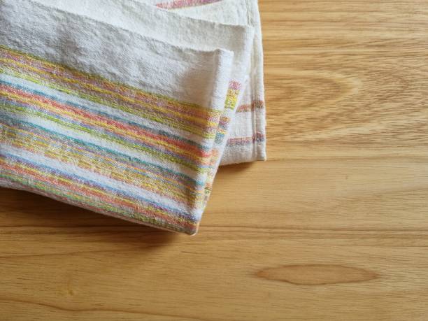 istock Kitchen towel on wooden cutting board 2103949571