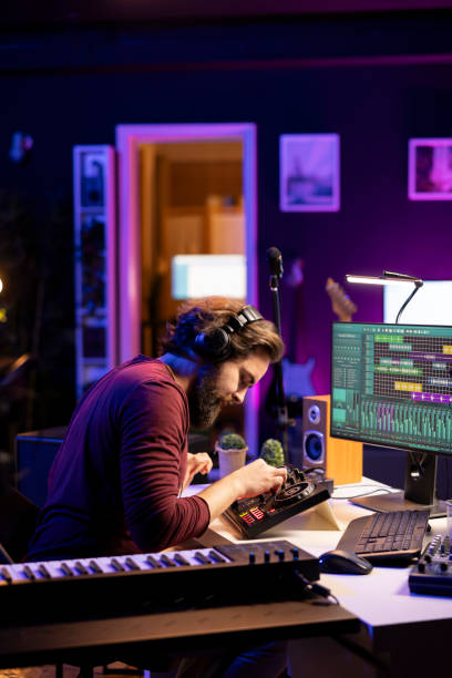 istock Music engineer using mixing console to add sound effects on tracks 2103951110