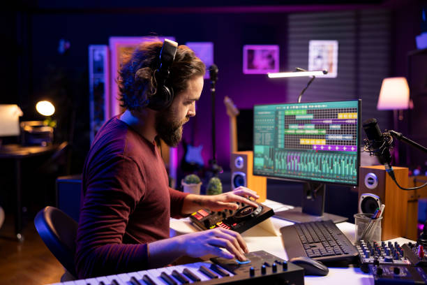 istock Sound engineer editing soundtracks and adjusting volume levels with daw software 2103951643
