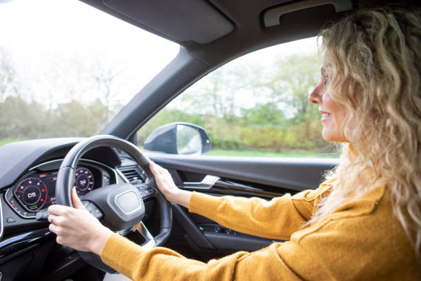 istock Woman driving on open road 2103958872