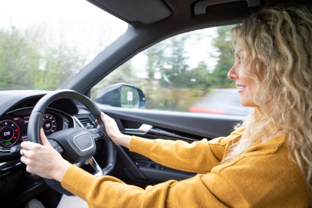 istock Woman driving on open road 2103958961