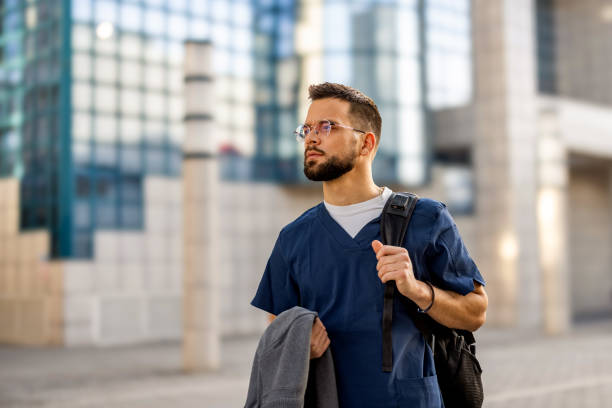 istock Young male nurse arrives to work 2103969694