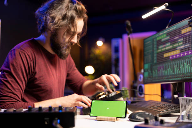 istock Composer singer mixing tunes on soundboard in home studio 2103973856