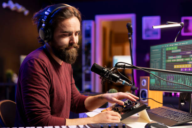 istock Young composer musician singing lyrics on microphone in his home studio 2103980128