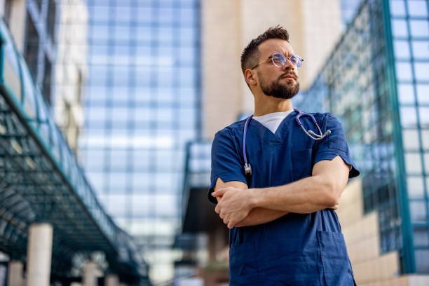 istock Confident male nurse outside looking away 2103981143
