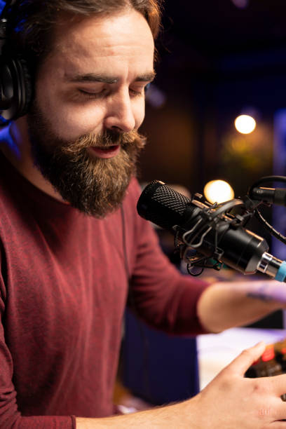 istock Talented music producer singing his verses on microphone in post production 2103981664