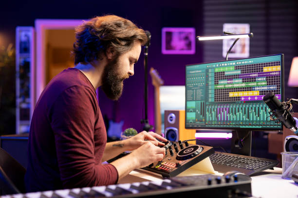 istock Music producer hitting pre amp knobs to edit soundtracks 2103984777