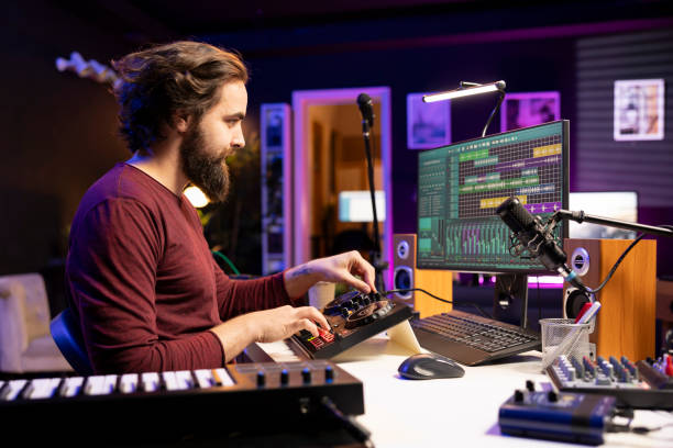 istock Male composer producing sounds and mixing them on stereo console 2103985853