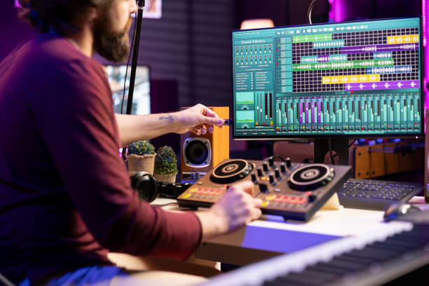 istock Professional artist using an usb stick to edit audio recordings in home studio 2103989473