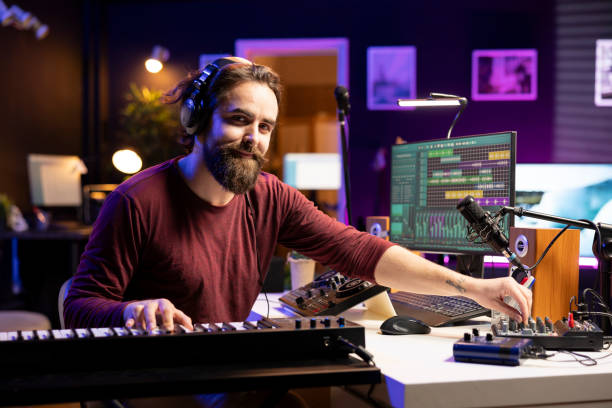 istock Portrait of male singer playing electronic keyboard notes 2103993132