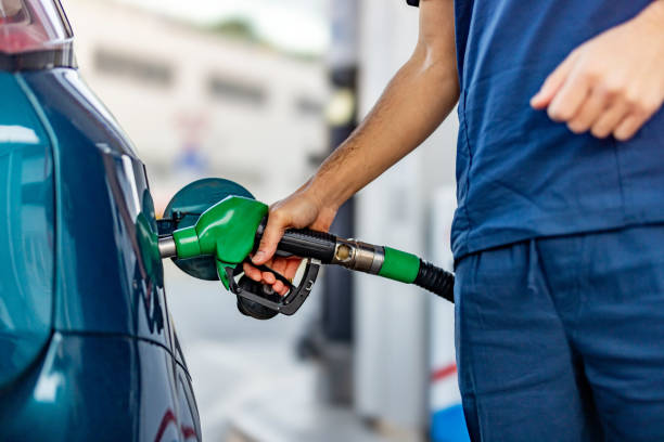 istock Young man refuelling his modern car at petrol station 2104000039
