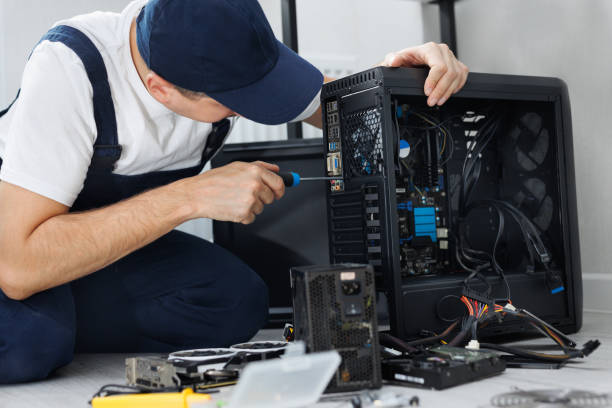istock Closeup computer technician holding a screwdriver and repairing a pc. 2104002174